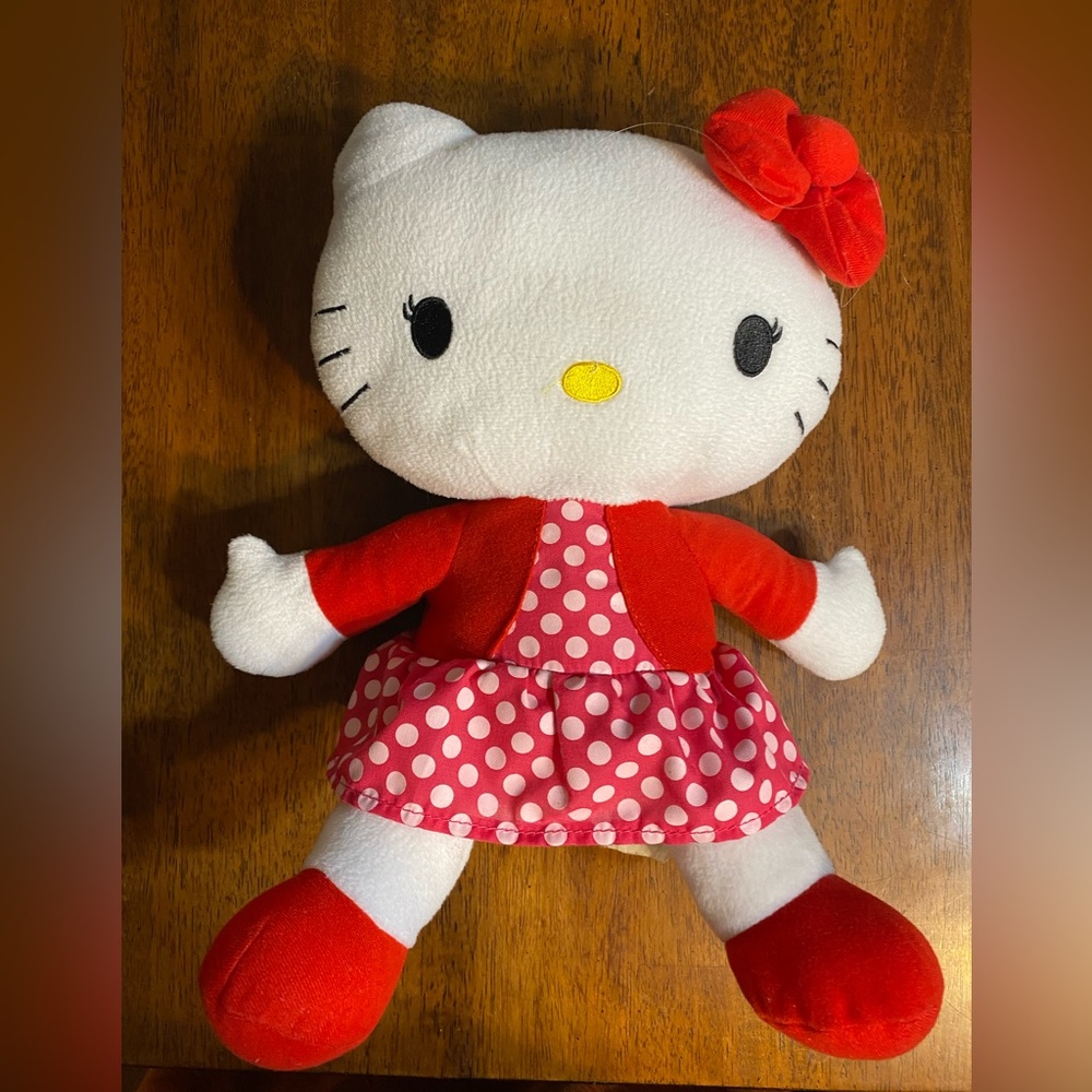 Hello Kitty plush. Sanrio Co. Approximately 14 inches long.  Red polkadot dress.